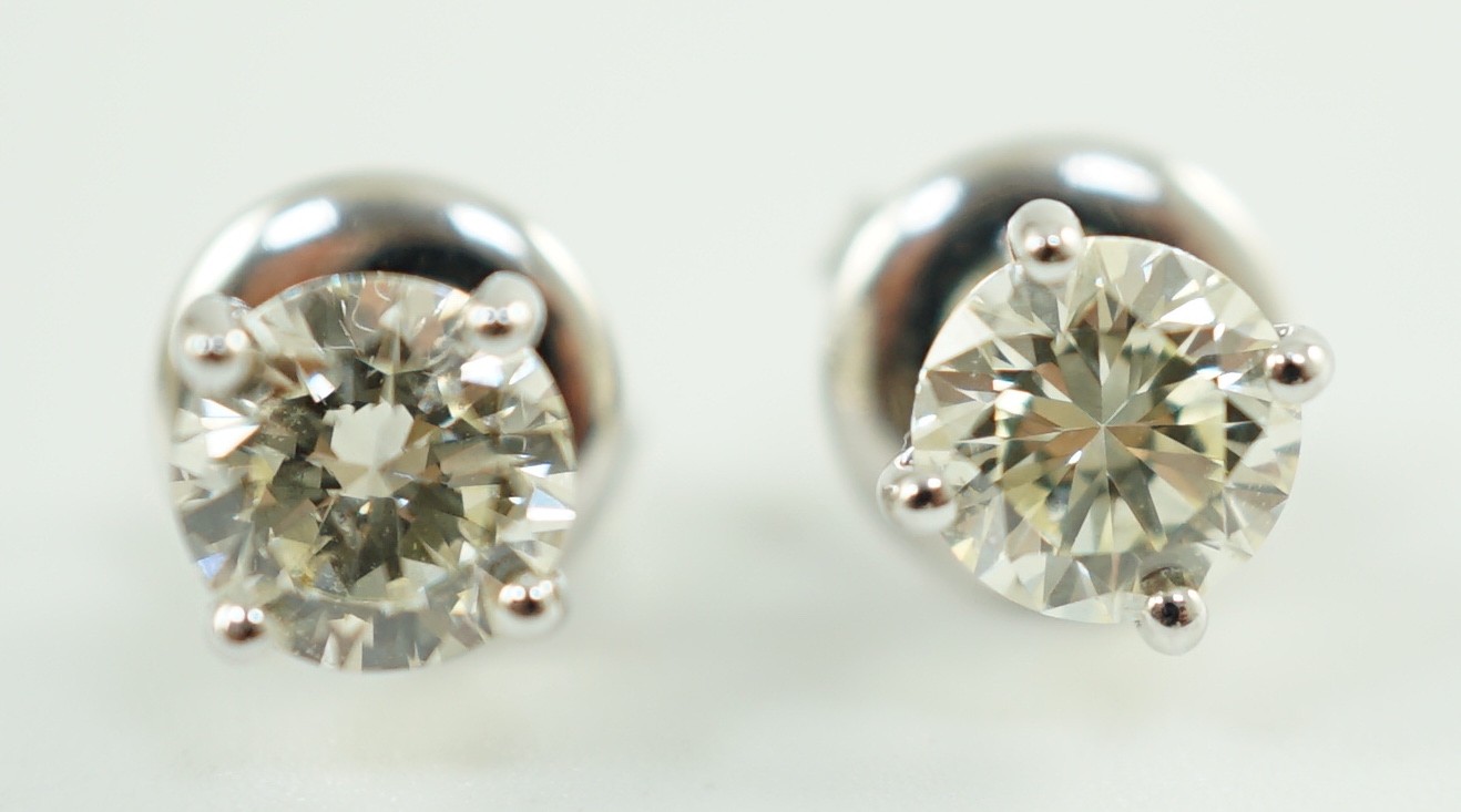 A pair of 18ct white gold and solitaire diamond set ear studs